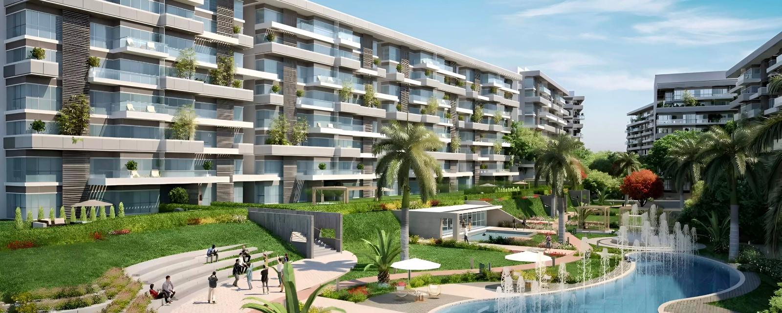 عمارات سكنية متدرجة تطل على حمام سباحة ومساحات خضراء في كمبوند سين 7، R7 العاصمة الإدارية — صورة تسويقية